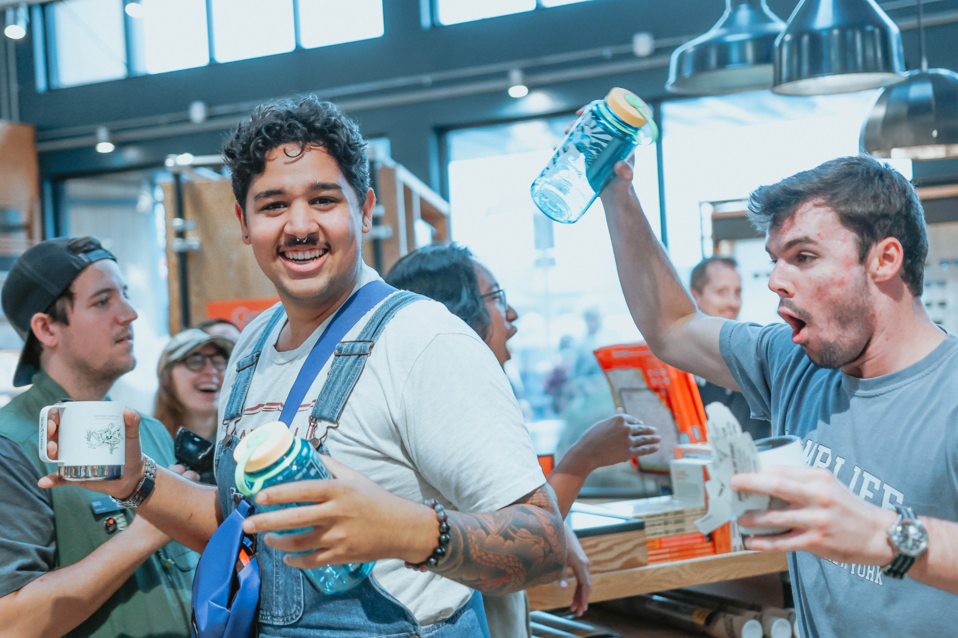 Customers celebrating with REI water bottles in store.