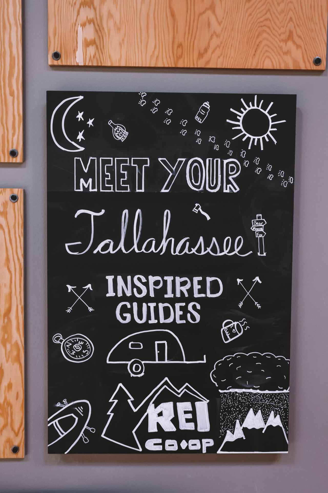 Hand-lettered REI Tallahassee chalkboard sign.